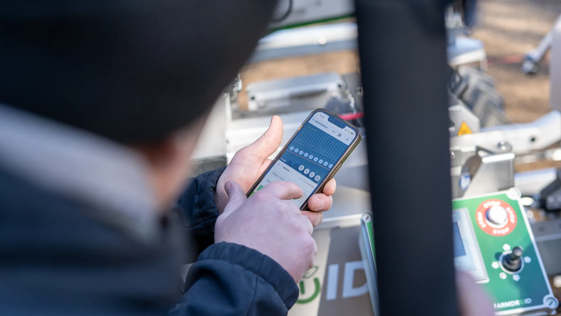 FarmDroid app being used in the field while farmer is looking