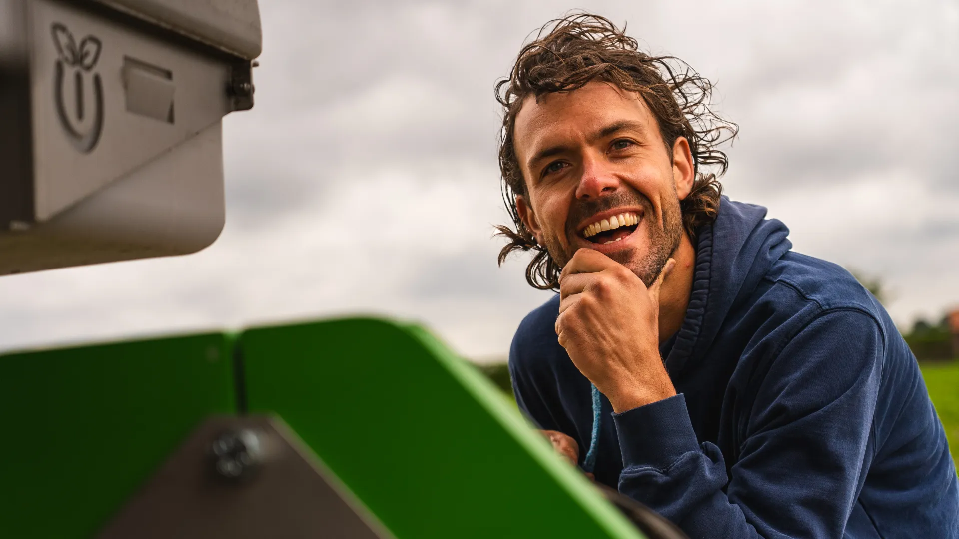 Jack Simons smiling sitting with his FarmDroid FD20 in the field