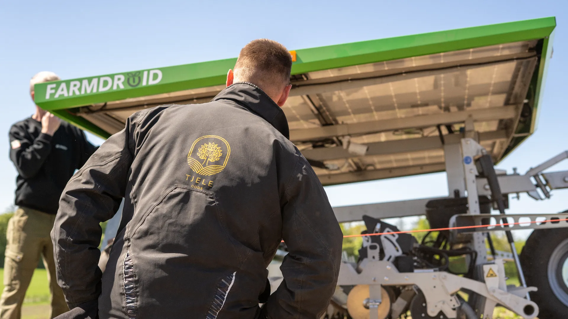 Farm Manager Steffen Rohde Døssing sitting next to the FarmDroid FD20 in the organic fodder beet field