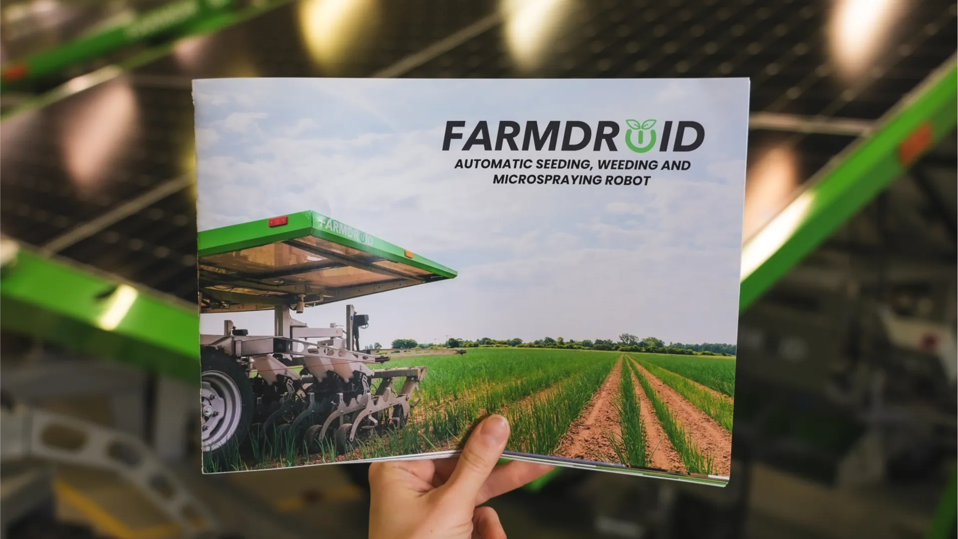 Hand holding FarmDroid brochure