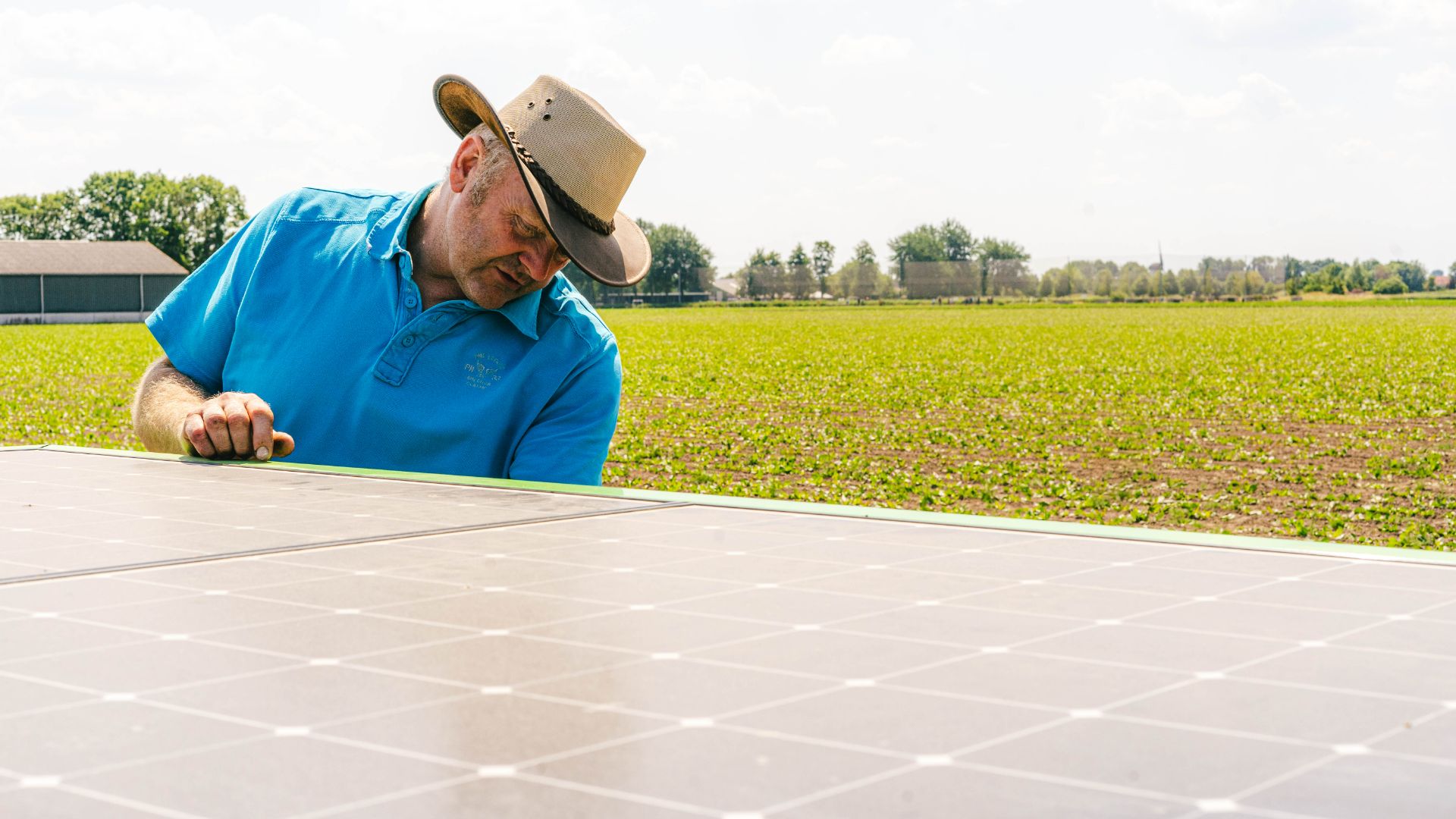Pieter-Jan Visser, a farmer from the Netherlands, standing with a FarmDroid FD20 robot in his field, showcasing the integration of technology in chicory cultivation."