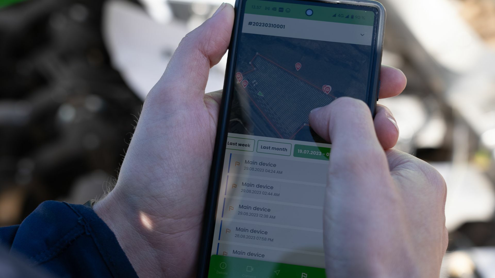 Farmer holding a smartphone with the FarmDroid App overview
